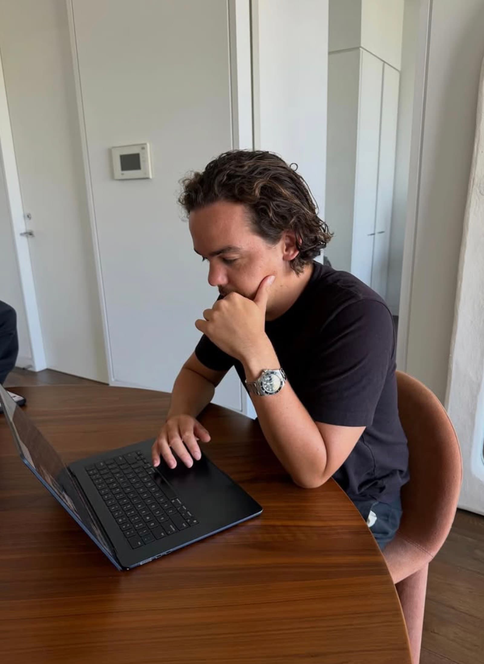 Noah working at his laptop